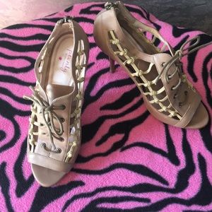 A spectator, open toe, lace wooden stilettos